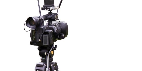 Professional video camera set on a tripod.