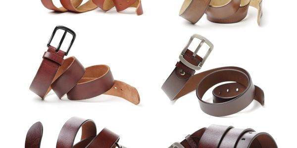 A collection of brown leather belts with various buckles.