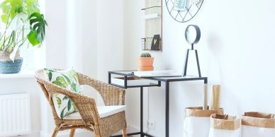 Bright home office with wicker chair and simple desk.