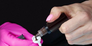 Applying gel nail polish during a manicure session.