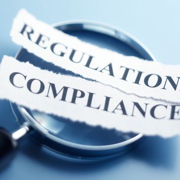 Magnifying glass focusing on torn paper with 'REGULATION' and 'COMPLIANCE' text.