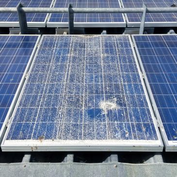 Damaged solar panel with dirt and cracks.