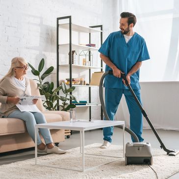 Caregiver assisting a senior woman with housekeeping
