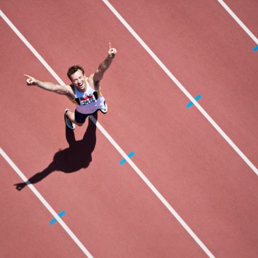Athlete celebrating victory on the running track.