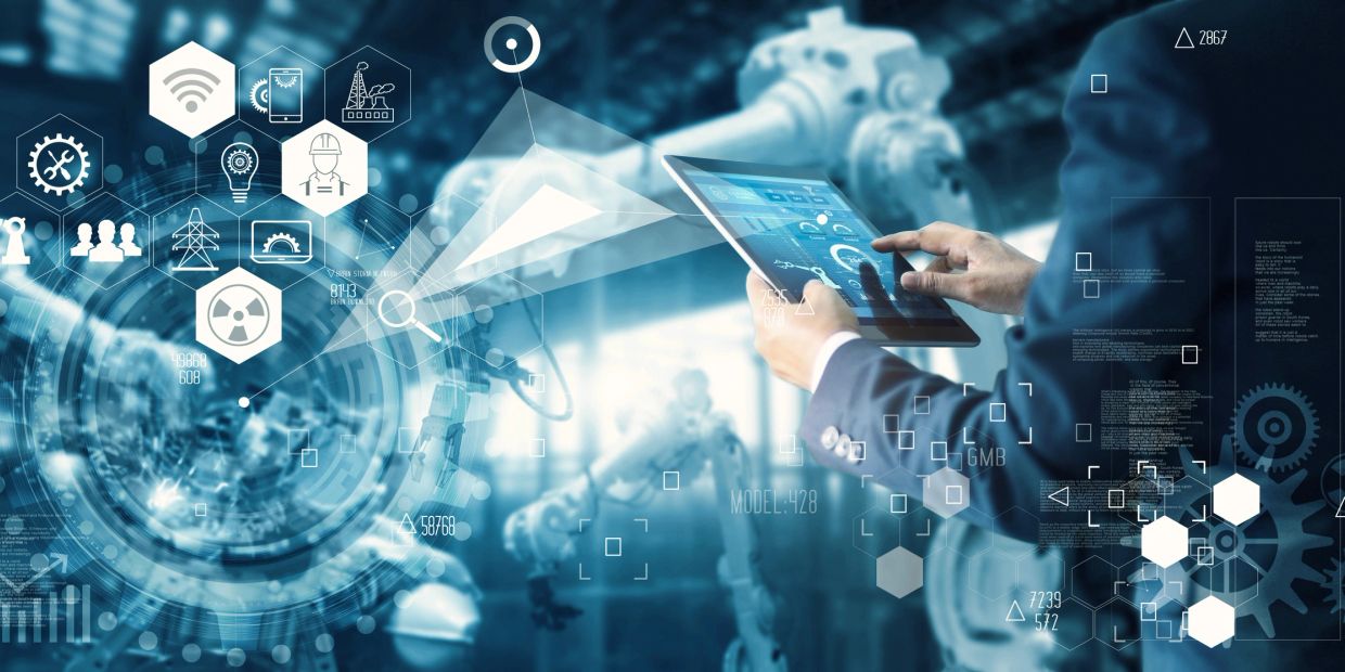 Person using digital tablet with industrial automation icons.