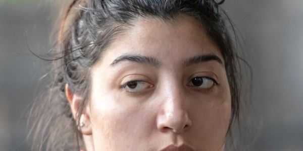 Close-up of a woman's contemplative face with natural lighting.