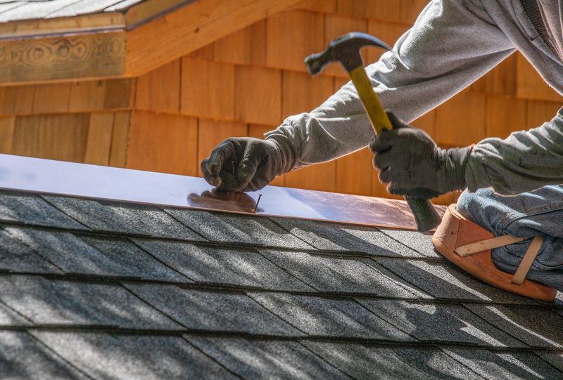 Installing new roof with  nail gun and shingles