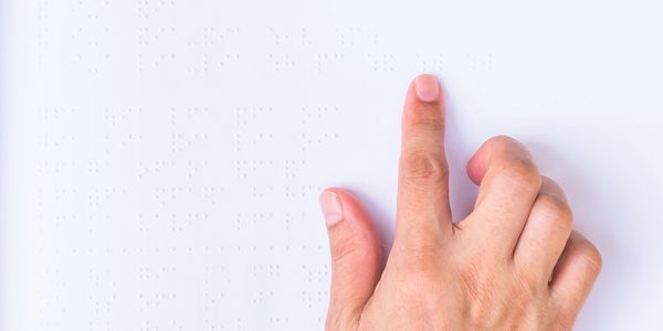 a hand with pointer finger pressing down on surface