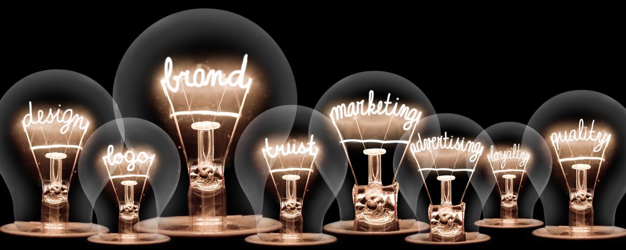 Light bulbs glowing with marketing and design terms.
