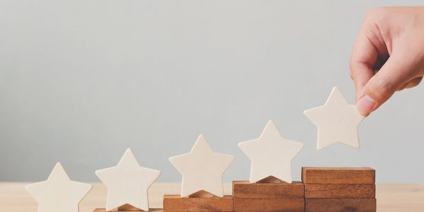 A person is standing on the stairs with five stars.