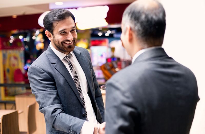 Indian businessmen handshake at coffee shop