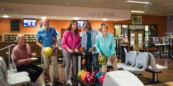 Group of friends bowling and enjoying.