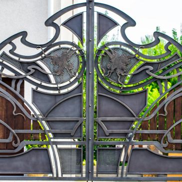 Intricately designed metal gate with artistic patterns and mythical creatures.