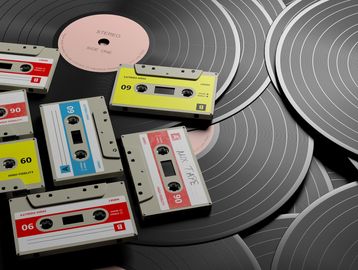 Vintage cassette tapes and vinyl records arranged together in a nostalgic music collection.