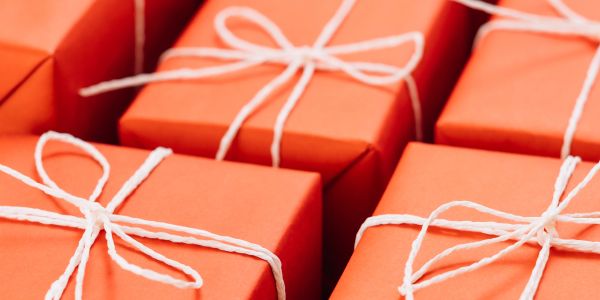Orange gift boxes tied with white string bows.