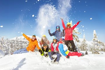 Group of friends enjoying snow in winter.