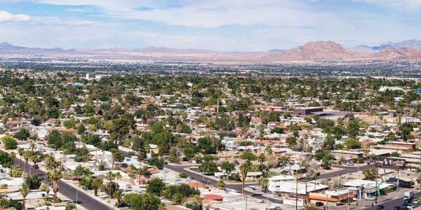 A sprawling suburban neighborhood with mountains in the background.