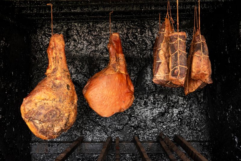 View of serrano ham and pork in a artisanal smokehouse