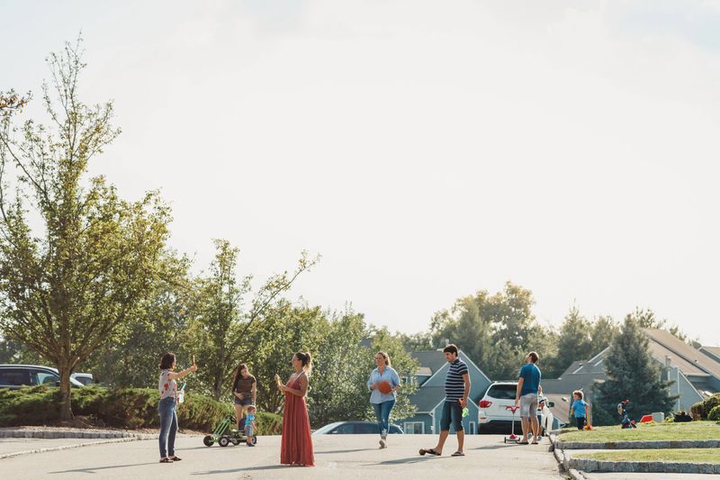 Neighbors talking and kids playing