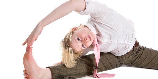 A young person on the floor, easily stretching and displaying great flexibility
