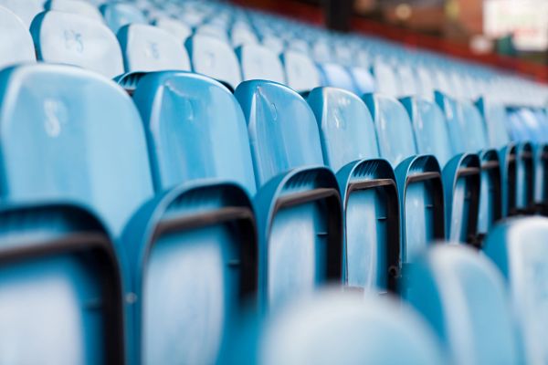 Rows of empty blue stadium seats.