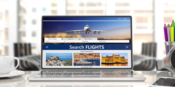 Laptop displaying a flight booking website.