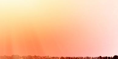 Sunset with a silhouetted crowd at the bottom.