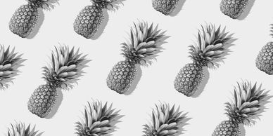 Pattern of pineapples on a bright yellow background.