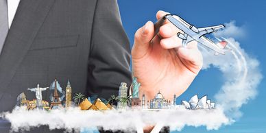 Hand holding airplane over famous landmarks and clouds.