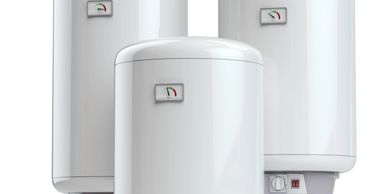 Three white electric water heaters with temperature gauges and control knobs.