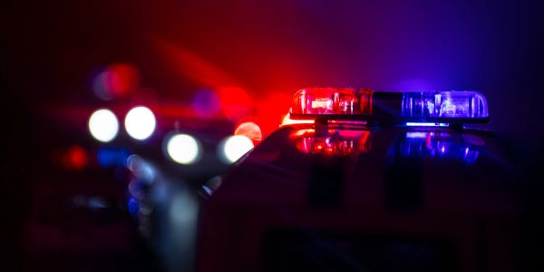 Flashing red and blue police lights at night.