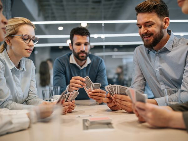 Businesspeople playing cards in office.