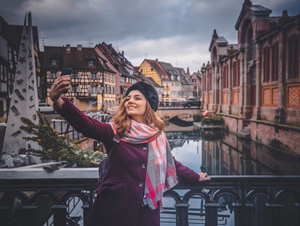 Woman taking a selfie on a picturesque bridge.