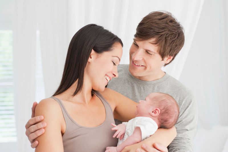 Smiling parents holding baby
