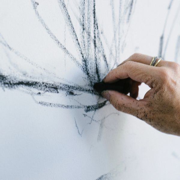 Hand drawing abstract black charcoal lines on white canvas.