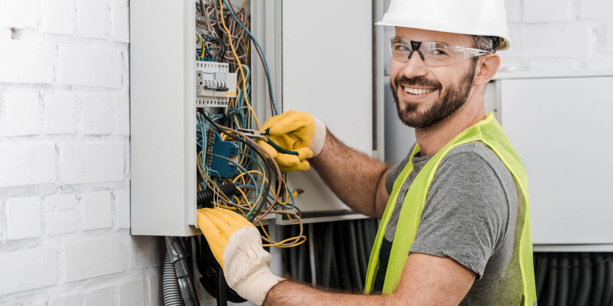 Electrician working on a circuit breaker panel.