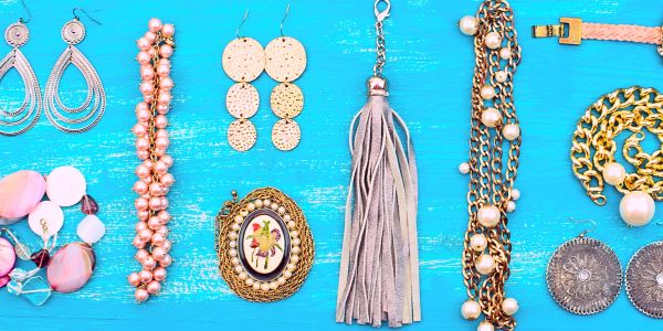 A colorful assortment of jewelry and accessories on a blue wooden surface.