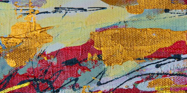 Close-up of vibrant abstract painting with gold, red, and blue textures on canvas.