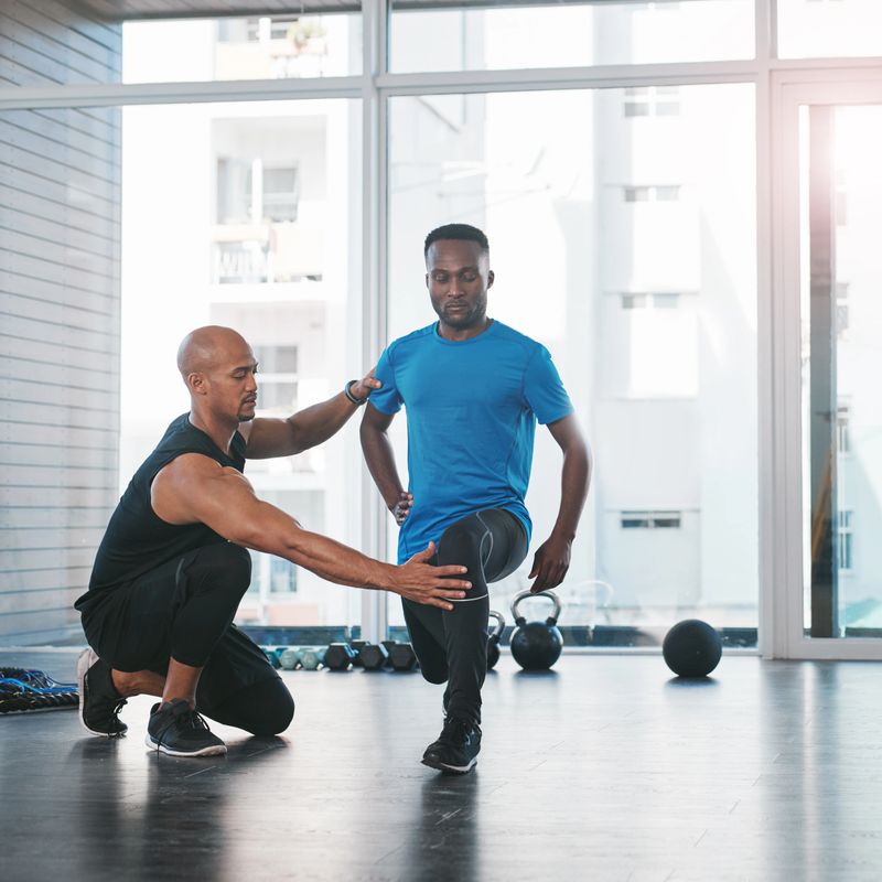 Shot of a man working out with his trainer