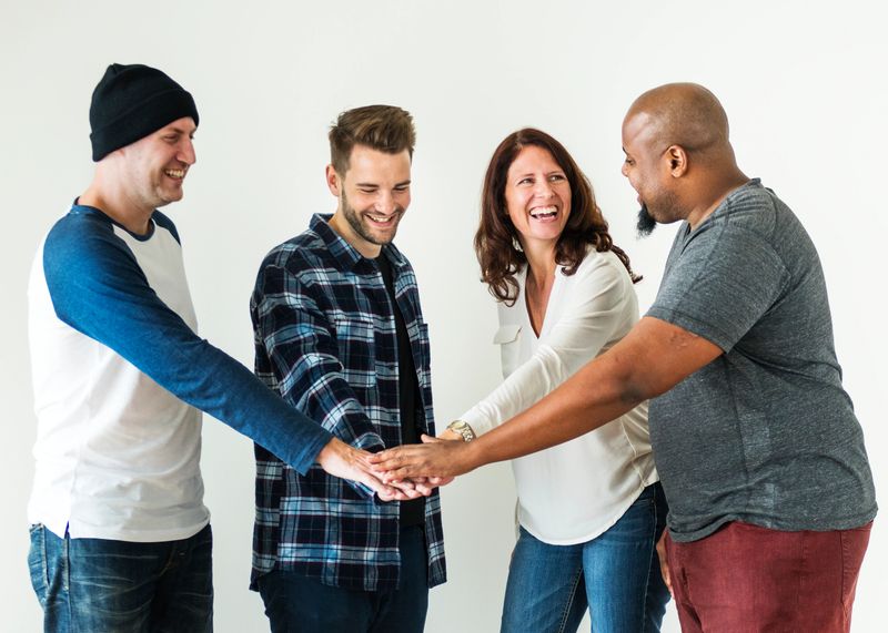 Diverse people joining hands together teamwork and community concept