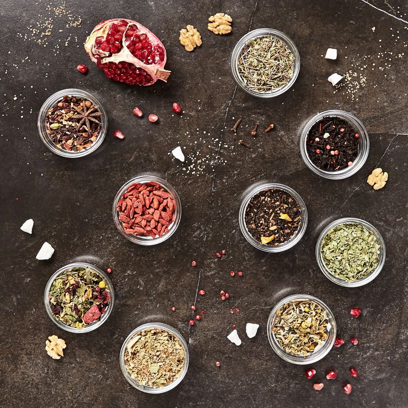 Big Set of Dried Green, Black and Herbal Tea Mixes Top View Flat Lay on Natural Background. Dry Organic Healthy Tea Leaves, Fruits, Flowers, Goji Berries, Jasmine, Hibiscus and other Herbs and Spices