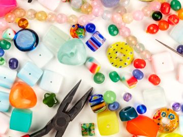 Various colorful beads and jewelry-making tools.