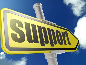 Yellow road sign with the word 'Support' against a blue sky.