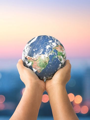 World globe held in hands.