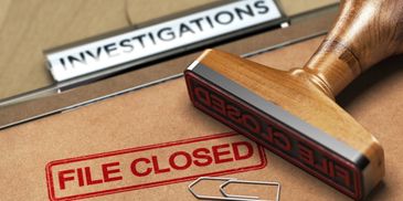 A file folder with an 'Investigations' label stamped 'FILE CLOSED'.
