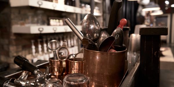 Copper utensils and bar tools in a cafe setting.