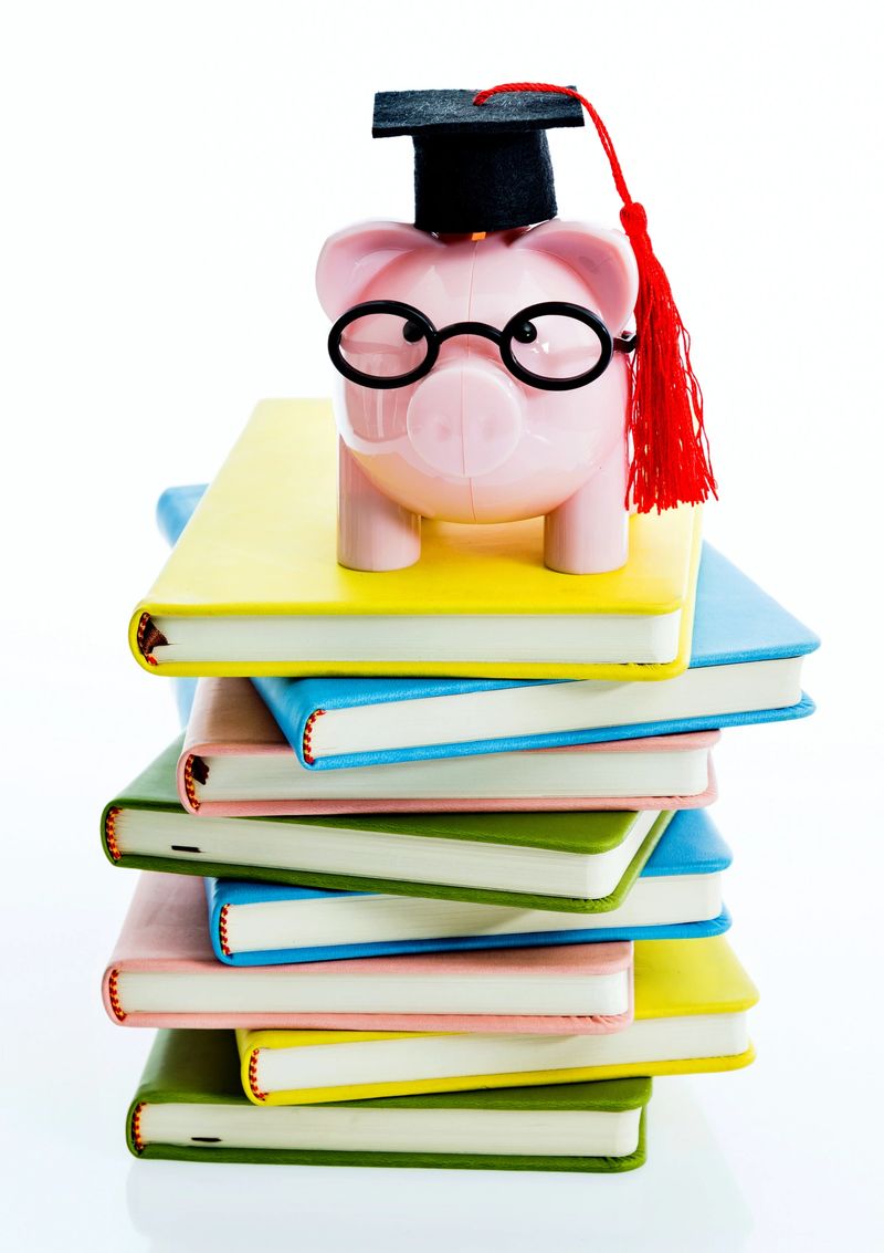 Piggy bank on top of stack of books.