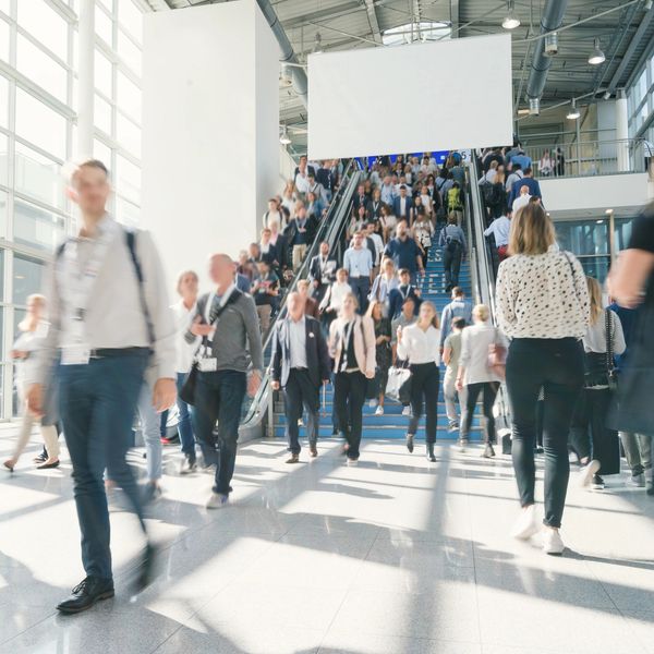 Crowds entering a large Arlington convention venue hosting federal, tech, and defense events.