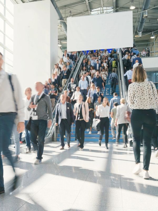 Attendees entering a busy Indianapolis convention hall during a major trade show event.
