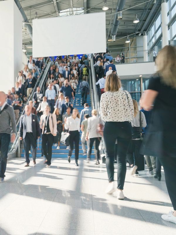 Attendees moving through a Los Angeles convention hall during a major expo or corporate event.
